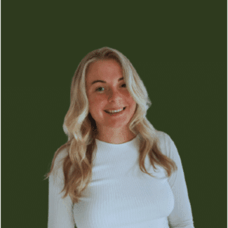 Teresa Leatherow smiling at the camera against a green background.
